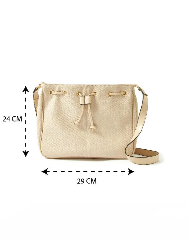 Accessorize London women's Faux Leather Cream Drawstring Weave Sling bag